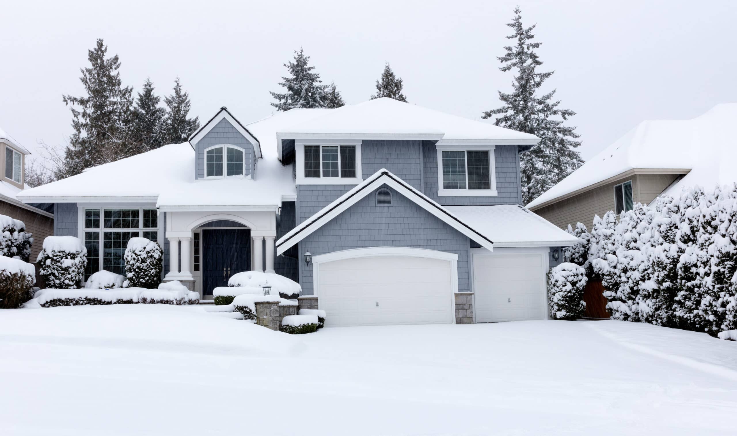 Front view of falling snow with home during rare storm in United States